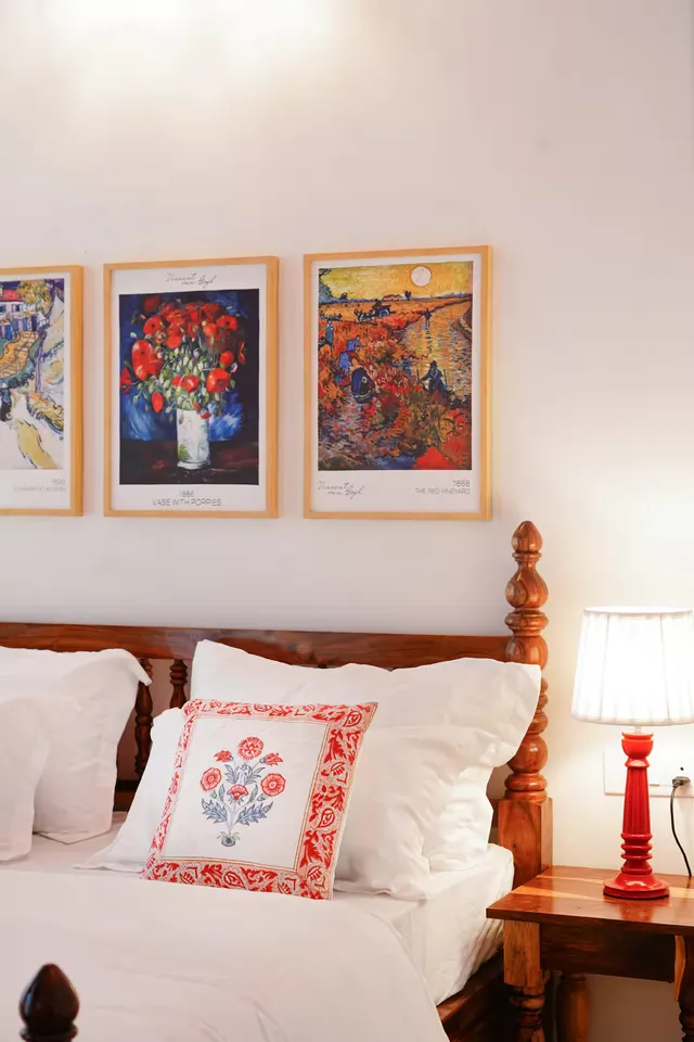 Aurora Luxe Residence — bedroom with bold European poster art