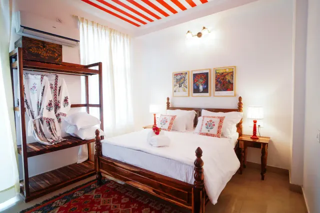 Aurora Luxe Residence — carved wooden four-poster bed