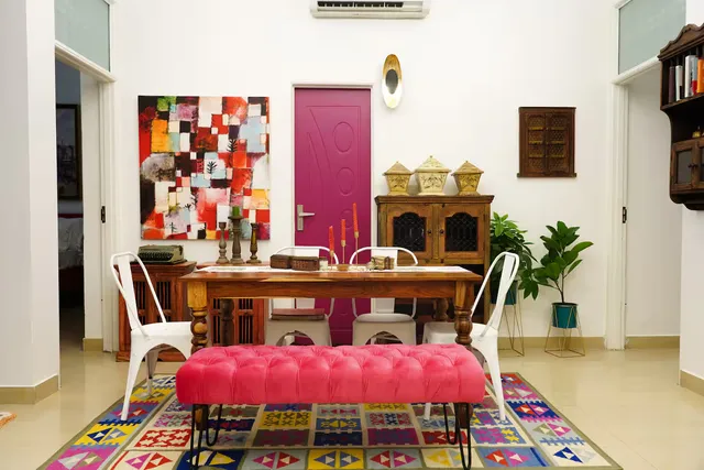 Met Luxe Galleria — dining room with bold pink bench and curated art