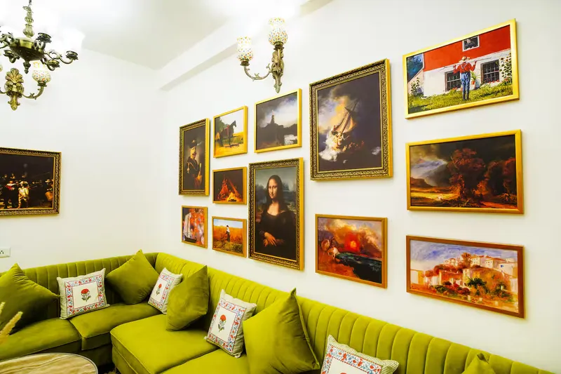 Met Luxe Galleria — chandelier-lit lounge with gallery wall of masterpieces, Jaipur