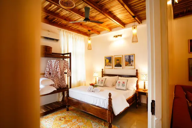 Timber Luxe Ateliér — bedroom with teak ceiling and curated art