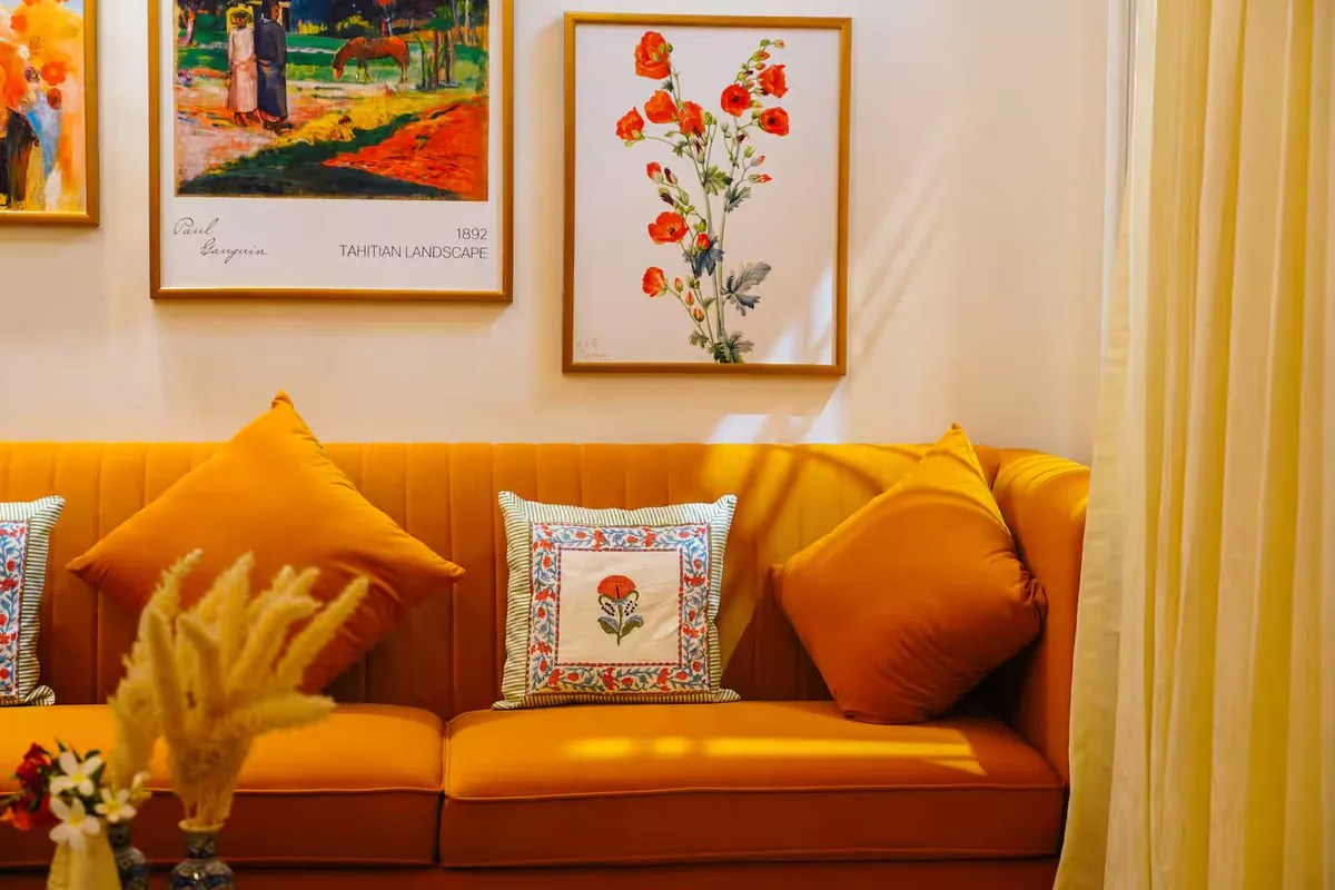 Timber Luxe Ateliér — golden lounge with gallery wall of European art, Jaipur